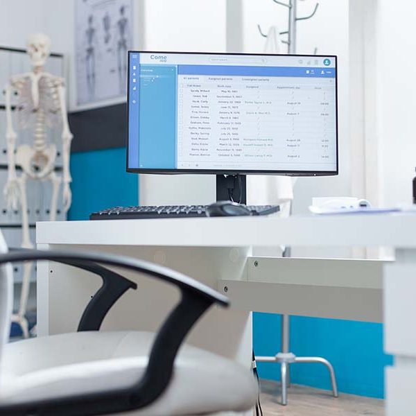 Computer with medical patient files on screen standing on table Computer with medical patient files on screen standing on table